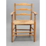 AN ARTS AND CRAFTS ELBOW CHAIR, 19th century, in ash with rush seat, the back with three arched