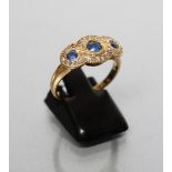 A LATE VICTORIAN SAPPHIRE AND DIAMOND DRESS RING, the three graduated facet cut sapphires within a