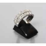 A DIAMOND HALF HOOP ETERNITY RING, the twenty round brilliant cut stones totalling approximately 1.