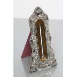 AN EDWARDIAN EASEL BACK SILVER THERMOMETER, maker's mark RP, London 1902, of shaped vertical form,