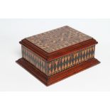 A VICTORIAN WALNUT PARQUETRY BOX of oblong form, the hinged lid opening to a void interior, the