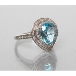 A TOPAZ AND DIAMOND COCKTAIL RING, the pear cut blue topaz of approximately 4.40cts claw set to a