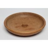 A ROBERT THOMPSON ADZED OAK FRUIT BOWL of shallow form centred by a carved mouse trademark in high