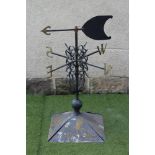 A METAL WEATHER VANE, 20th century, the domed square base with baluster surmount issuing a turned