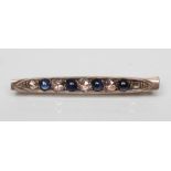 A SAPPHIRE AND DIAMOND BAR BROOCH, the four circular cabochon polished sapphires with five rose