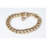 A FLAT CURB LINK CHAIN BRACELET, stamped 585, with fine safety chain stamped 9k, 8 1/2" long, 51.