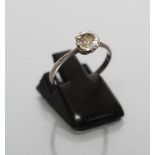 A SOLITAIRE DIAMOND RING, the old brilliant cut stone of approximately 0.6cts, claw set to an