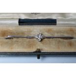 AN EDWARDIAN DIAMOND BROOCH, the propellor bars centred by four open back collet set old and