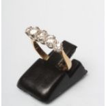 A FIVE STONE DIAMOND RING, the graduated round brilliants claw set to a plain shank stamped 18ct,