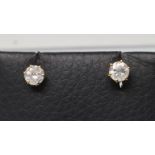 A PAIR OF SOLITAIRE DIAMOND EAR STUDS, the round brilliant cut stones totalling approximately 1.