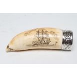 A SCRIMSHAW engraved with a three masted sailing ship off a palm island below clouds on a stained