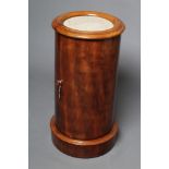 A VICTORIAN MAHOGANY CYLINDRICAL BEDSIDE CUPBOARD, the moulded edged top with inset white marble,