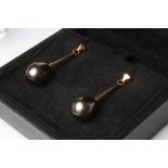 A PAIR OF TAHITIAN PEARL EAR BOBS, the tear shaped pearls drilled and peg set to a tapering