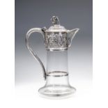 A LATE VICTORIAN GLASS CLARET JUG, maker Charles Boyton, London 1894, of cylindrical form with swept