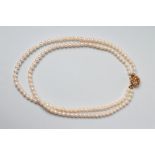 A DOUBLE STRING CULTURED PEARL NECKLACE, the seventy three and sixty five pearls on an 18ct gold