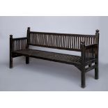 AN ARTS AND CRAFTS WOODEN BENCH of painted slatted form, the mildly raked back with straight top