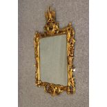 A GEORGIAN STYLE CARVED AND GILT WOOD PIER GLASS, 19th century, in the rococo taste with eagle