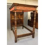 A CARVED AND JOINED OAK CANOPY BEDSTEAD, 19th century, with red and gold silk brocade drapery, the