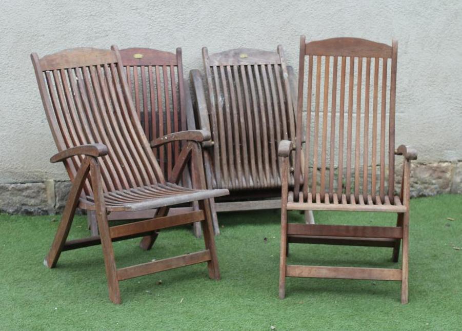 A SET OF FOUR TEAK FOLDING CHAIRS by Royal Croft, of slatted steamer type with arched top rails,