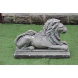 A COMPOSITE STONE RECUMBENT LION, raised on stepped oblong base, 30" x 12" x 20" (Est. plus 21%