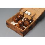 A SET OF EIGHT LIGNUM VITAE LAWN BOWLING BALLS together with a pair of Jacks, the latter