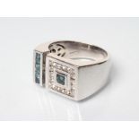 A GENTLEMAN'S DRESS RING, the asymmetric square and oblong panels channel set with white and blue