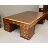 A LARGE MAHOGANY LIBRARY DESK, c.1900, the moulded edged top inset with brown leather, each short