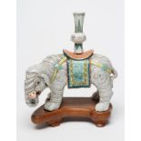 A CHINESE PORCELAIN JOSS STICK HOLDER/INCENSE BURNER modelled as an elephant with orange, green