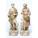 A LARGE PAIR OF ROYAL DUX BISQUE PORCELAIN FIGURES, early 20th century, modelled as a young goatherd