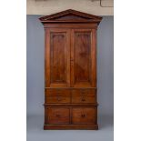 A MAHOGANY ESTATE CUPBOARD, early 19th century, the moulded pediment and plain frieze over two doors