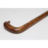 A CRIMEAN WAR PENWORK CANE, with carved beast's head to the top, penwork serpent to the grip,