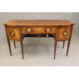 A GEORGIAN MAHOGANY SIDEBOARD, third quarter 18th century, of bowed breakfront form crossbanded with