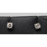 A PAIR OF SOLITAIRE DIAMOND STUD EARRINGS, the claw set round brilliant totalling approximately 0.