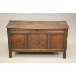 AN OAK PANELLED COFFER, c.1700, the hinged moulded edged plank lid with chip end carving opening