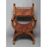 A SPANISH OAK X FRAMED ARMCHAIR, 20th century, the carved square section uprights with lion head