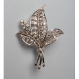 A DIAMOND LEAF BROOCH, the three open work leaves point set with small round brilliant cut stones