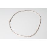 A DIAMOND LINE NECKLACE, the twenty six oblong panels each point set with seven small brilliant