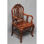 A CHINESE HARD WOOD ARMCHAIR carved throughout with bamboo, arched back with carved splat