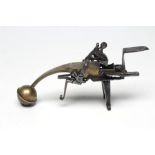 AN 18TH CENTURY FLINTLOCK TINDER LIGHTER, of brass and steel construction, top action engraved