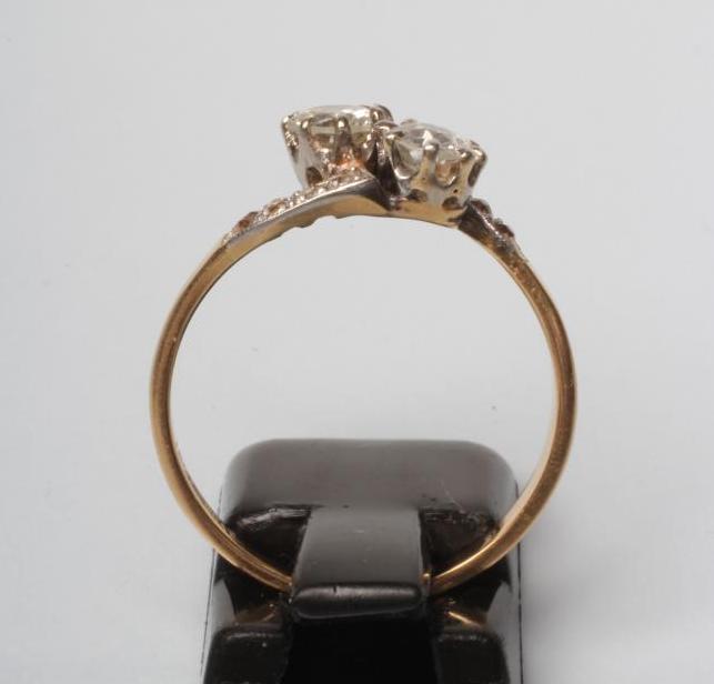 A TWO STONE DIAMOND CROSSOVER RING, the round cut stones each of approximately 0.5cts claw set to - Image 2 of 3