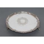 A LATE VICTORIAN SALVER, maker G.M. Jackson, London 1892, of shaped circular form, the gadroon