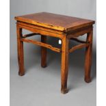 A CHINESE HARDWOOD SIDE TABLE, the cleated top over a waved frieze with moulded banding, raised on