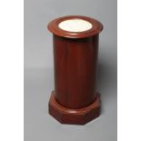 A VICTORIAN MAHOGANY CYLINDRICAL BEDSIDE CUPBOARD, the moulded edged top inset with white marble,