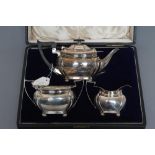 A BACHELOR'S COMPOSITE EDWARDIAN THREE PIECE TEA SERVICE, maker's mark J.R., Sheffield 1904 (teapot)