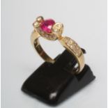 A RUBY AND DIAMOND COCKTAIL RING, the circular facet cut ruby prong set between two pairs of diamond