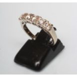A FIVE STONE DIAMOND RING, the round brilliant cut stones point set to a plain 18ct gold shank,