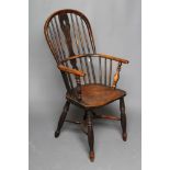 A WINDSOR SPINDLE BACK ARMCHAIR in ash and elm, late 19th century, of high hooped form with shaped