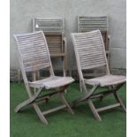 A SET OF FOUR TEAK FOLDING GARDEN CHAIRS with slatted seat and back on shaped square section