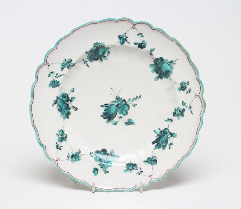 A CHELSEA PORCELAIN PLATE, c.1755, of fluted circular form, painted en camaieu green in the