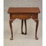 A GEORGIAN MAHOGANY FOLDING TEA TABLE, mid 18th century, of rounded oblong form with centre